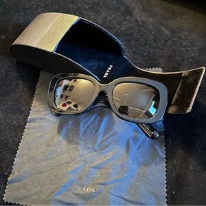 Prada Elegant Black Curved Sunglasses